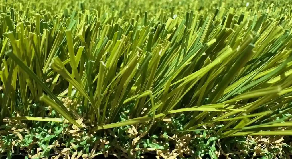 A close-up view of the dense, multi-toned blades of Texas Tuff's Alamo turf grass, a high-quality artificial grass product for installation in the DFW area.
