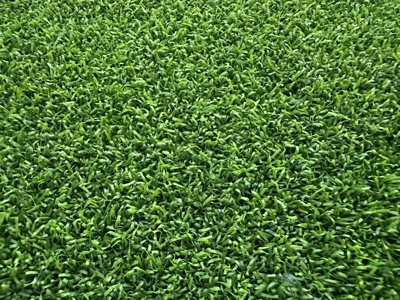 Augusta putting green artificial turf, a professional-grade solution with a ½” pile height polyethylene emerald and field green grass, designed for the most realistic ball roll.