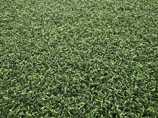 Premium St. Andrews artificial grass, nylon for durability, offering a smooth ball roll.