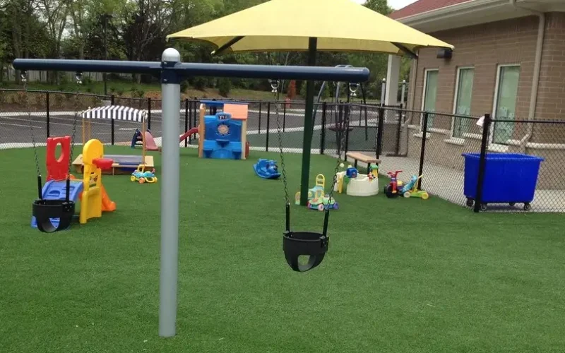 Safe playground turf installed with play equipment in Dallas, TX.